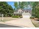 Traditional home featuring an attached garage, well-kept lawn, and a neatly landscaped front yard at 4315 Summit Heights Dr, Snellville, GA 30039