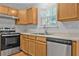 Functional kitchen features wooden cabinets, stainless steel appliances, and a window with natural light at 4315 Summit Heights Dr, Snellville, GA 30039