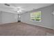 Inviting living room featuring plush carpet, a large window, and a staircase at 4315 Summit Heights Dr, Snellville, GA 30039