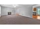 Spacious living room with fireplace, neutral carpet, and adjacent kitchen at 4315 Summit Heights Dr, Snellville, GA 30039