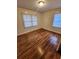 Bright bedroom boasts gleaming hardwood floors and plenty of natural light from large windows at 2368 Jernigan Se Pl, Atlanta, GA 30315
