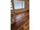 Living room with hardwood floors, open windows, and natural light; entry door is visible at 2368 Jernigan Se Pl, Atlanta, GA 30315