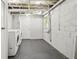 Unfinished basement laundry room with exposed ductwork and a washing machine and dryer at 2610 Crestdale Se Cir, Atlanta, GA 30316
