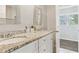 Bathroom featuring dual sinks, granite countertops, and a walk-in closet at 2610 Crestdale Se Cir, Atlanta, GA 30316