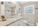 Modern bathroom with granite countertop, large mirror, and tiled shower-tub combo at 2610 Crestdale Se Cir, Atlanta, GA 30316