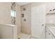 Tiled shower with glass accent tile and niche, complemented by granite counters and storage shelves at 2610 Crestdale Se Cir, Atlanta, GA 30316
