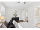 Bright bedroom with modern decor, ceiling fan, hexagon mirror, and a glimpse of the bathroom at 2610 Crestdale Se Cir, Atlanta, GA 30316