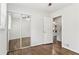 View into a bedroom with mirrored closets, natural light and hardwood floors at 2610 Crestdale Se Cir, Atlanta, GA 30316