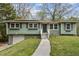 Charming home with green exterior, black shutters, lovely landscaping and a welcoming front porch at 2610 Crestdale Se Cir, Atlanta, GA 30316