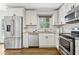 This kitchen is equipped with stainless steel appliances, white cabinets, and granite countertops at 2610 Crestdale Se Cir, Atlanta, GA 30316