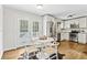Bright kitchen and dining area with modern appliances, white cabinetry, hardwood floors, and access to outdoor space at 2610 Crestdale Se Cir, Atlanta, GA 30316