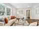Bright living room with neutral tones, modern furniture, hardwood floors, and natural light from the large windows at 2610 Crestdale Se Cir, Atlanta, GA 30316