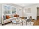 Bright living room with neutral tones, modern furniture, hardwood floors, and natural light from the large windows at 2610 Crestdale Se Cir, Atlanta, GA 30316