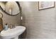 Elegant powder room featuring wallpaper, modern fixtures, and a round mirror at 307 Cherokee Se Ave # 3, Atlanta, GA 30312