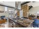 Open kitchen featuring granite countertops, stainless steel appliances and a decorative stone wall at 307 Cherokee Se Ave # 3, Atlanta, GA 30312