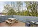 Relaxing rooftop deck with a picnic table, chairs, and surrounding greenery for enjoying the outdoors at 307 Cherokee Se Ave # 3, Atlanta, GA 30312