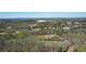 Expansive aerial view showcasing the home's location nestled amidst lush greenery, trees and distant mountains at 5388 Frazer Rd, Buford, GA 30518