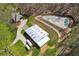 Aerial view of equestrian facilities featuring a barn, paddock, and potential riding arena at 5388 Frazer Rd, Buford, GA 30518