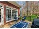 Relaxing outdoor deck with seating area overlooking a lush backyard and beautiful trees at 5388 Frazer Rd, Buford, GA 30518