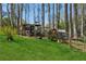 A charming chicken coop and run on a well-maintained lawn with mature trees, ready for poultry enthusiasts at 5388 Frazer Rd, Buford, GA 30518