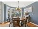 Cozy dining area with a round table, bay window, and scenic outdoor views at 5388 Frazer Rd, Buford, GA 30518