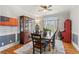 Formal dining room featuring wainscoting, hardwood floors, and natural light from a large window at 5388 Frazer Rd, Buford, GA 30518