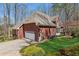 Beautiful brick home with attached garage, manicured lawn, and mature landscaping at 5388 Frazer Rd, Buford, GA 30518