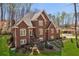 Inviting brick home with manicured lawn and landscaping in a beautiful wooded setting at 5388 Frazer Rd, Buford, GA 30518