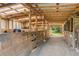 Interior view of barn featuring stalls and ample storage space at 5388 Frazer Rd, Buford, GA 30518