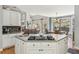 Open kitchen with island cooktop, breakfast nook, and views into the living room at 5388 Frazer Rd, Buford, GA 30518
