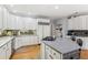 Bright kitchen with white cabinets, hardwood floors, and a center island at 5388 Frazer Rd, Buford, GA 30518