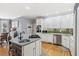 Spacious kitchen with a center island, modern appliances, and hardwood flooring at 5388 Frazer Rd, Buford, GA 30518