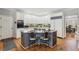 Open kitchen with island, white cabinets, stainless steel appliances, and a dining nook at 5388 Frazer Rd, Buford, GA 30518