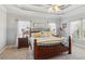 This main bedroom features a trey ceiling, neutral decor, and large windows at 5388 Frazer Rd, Buford, GA 30518