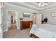 This spacious main bedroom features a trey ceiling, neutral decor and an ensuite bath at 5388 Frazer Rd, Buford, GA 30518