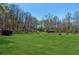Sprawling green pasture with grazing horses, surrounded by lush trees and offering a serene countryside view at 5388 Frazer Rd, Buford, GA 30518