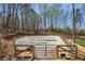 An outdoor horse riding arena surrounded by trees with gated entry at 5388 Frazer Rd, Buford, GA 30518