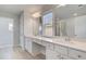 Bathroom featuring double sink vanity with white cabinets, quartz countertop, and tile floors at 624 Leafy Branch Way, Mcdonough, GA 30253