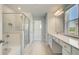 Bathroom with a tiled glass door shower, soaking tub, double sink vanity and tile floors at 624 Leafy Branch Way, Mcdonough, GA 30253