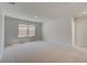 Spacious bedroom with plush carpeting, two windows, and en-suite bath at 624 Leafy Branch Way, Mcdonough, GA 30253