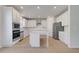 Well-lit kitchen featuring white cabinets, stainless steel appliances, and island at 624 Leafy Branch Way, Mcdonough, GA 30253