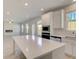Bright eat-in kitchen with stainless appliances, including oven and microwave, white cabinets and center island at 624 Leafy Branch Way, Mcdonough, GA 30253