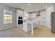 Modern kitchen featuring white cabinets, stainless steel appliances, and a large island at 624 Leafy Branch Way, Mcdonough, GA 30253