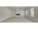 Light and airy living room features a modern fireplace, ceiling fan, light-colored flooring, and large windows at 624 Leafy Branch Way, Mcdonough, GA 30253
