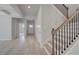 Inviting foyer features wood staircase with iron spindles and light wood flooring at 624 Leafy Branch Way, Mcdonough, GA 30253