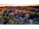An aerial view of a home surrounded by woods in a rural neighborhood with sunset in the background at 114 Hardwood Ln, Canton, GA 30115
