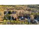 An aerial view of a neighborhood highlighting the property, lush trees and green surroundings at 114 Hardwood Ln, Canton, GA 30115