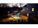 Aerial view of the backyard shows a pool with a slide, an outdoor kitchen, and manicured landscaping at 114 Hardwood Ln, Canton, GA 30115