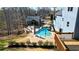 Aerial view of the backyard with pool, outdoor living, mature trees, and privacy fence at 114 Hardwood Ln, Canton, GA 30115