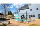 A well-manicured backyard featuring a pool with slide and a covered outdoor seating area at 114 Hardwood Ln, Canton, GA 30115